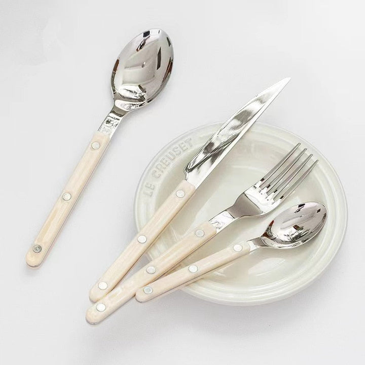 24-piece engraved stainless steel flatware set, includes forks, knives, and spoons.