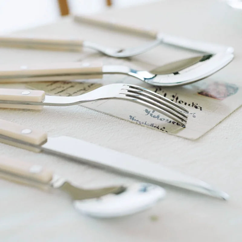 Modern elegant 24-piece engraved stainless steel cutlery set for contemporary dining.