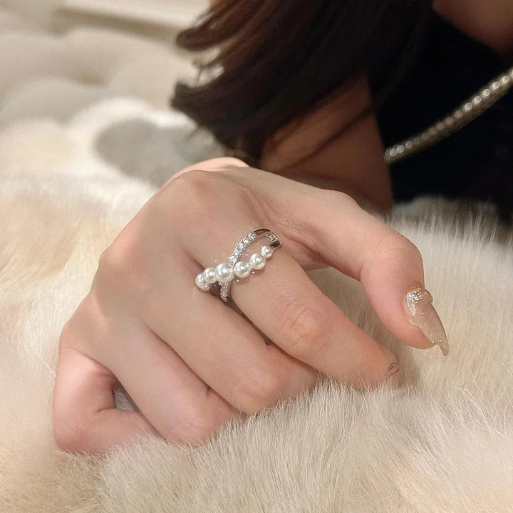 Beautiful women's adjustable ring, vintage, showcasing a central pearl and pave-set zirconia stones.