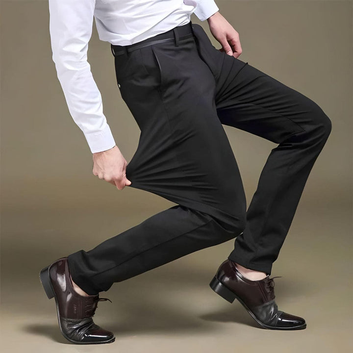 Man confidently wearing Alex stretch trousers, demonstrating comfortable movement and timeless classic style.