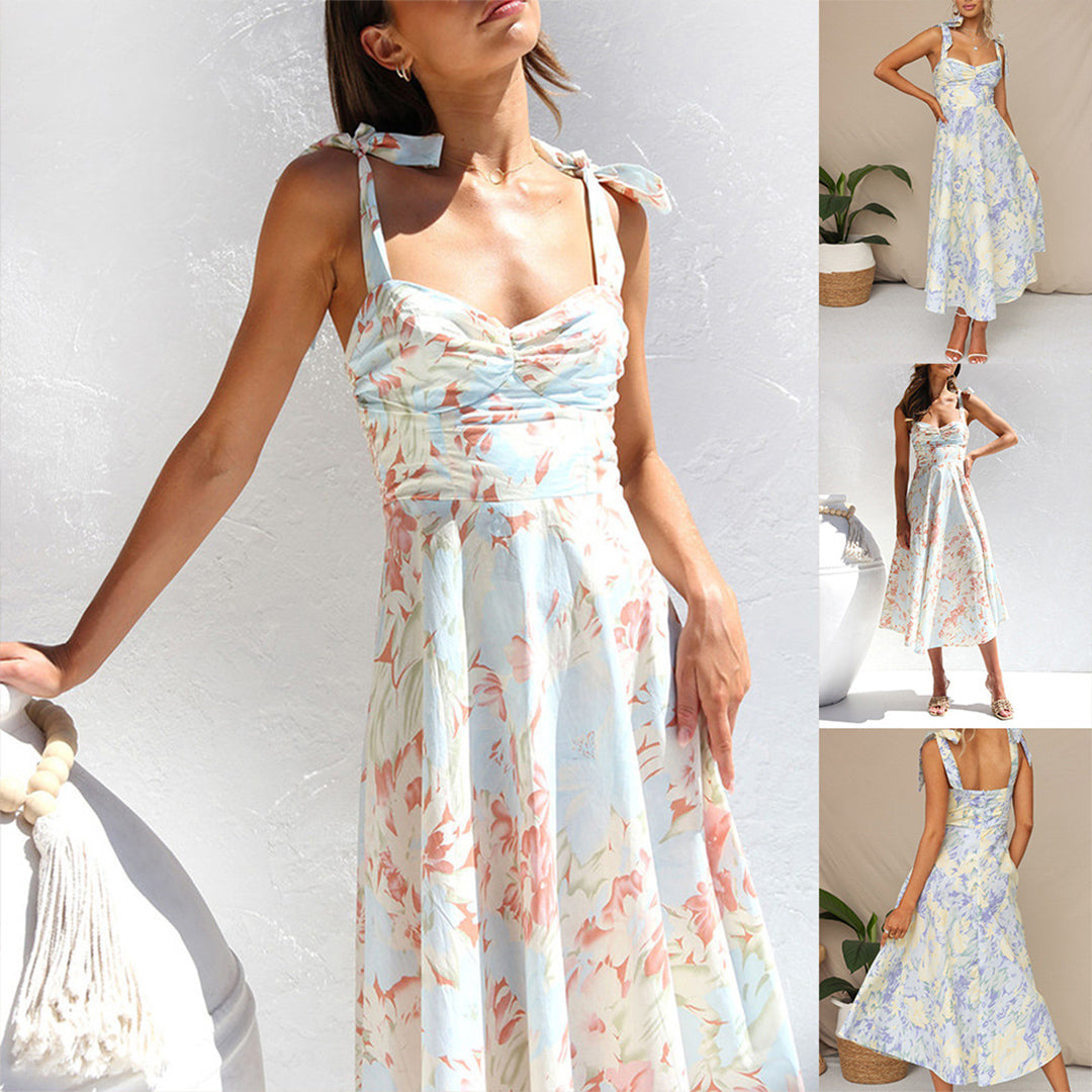 Woman wearing Alina floral midi dress, showcasing its flowing silhouette and summer style