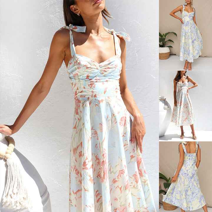 Woman wearing Alina floral midi dress, showcasing its flowing silhouette and summer style