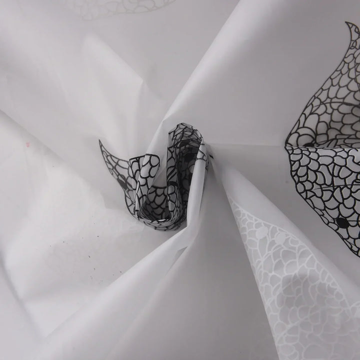 Close-up of AquaLeaf shower curtain fabric, highlighting leaf pattern and transparent material