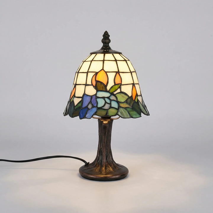 Decorative Aurafleur stained glass table lamp on a brushed nickel base, perfect as a bedside or accent light.