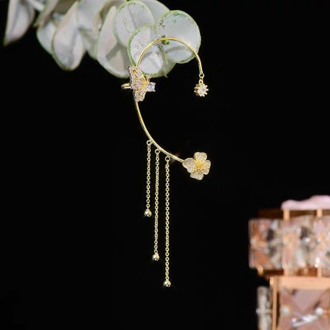Pair of delicate gold butterfly drop earrings for women, fashion jewelry in focus