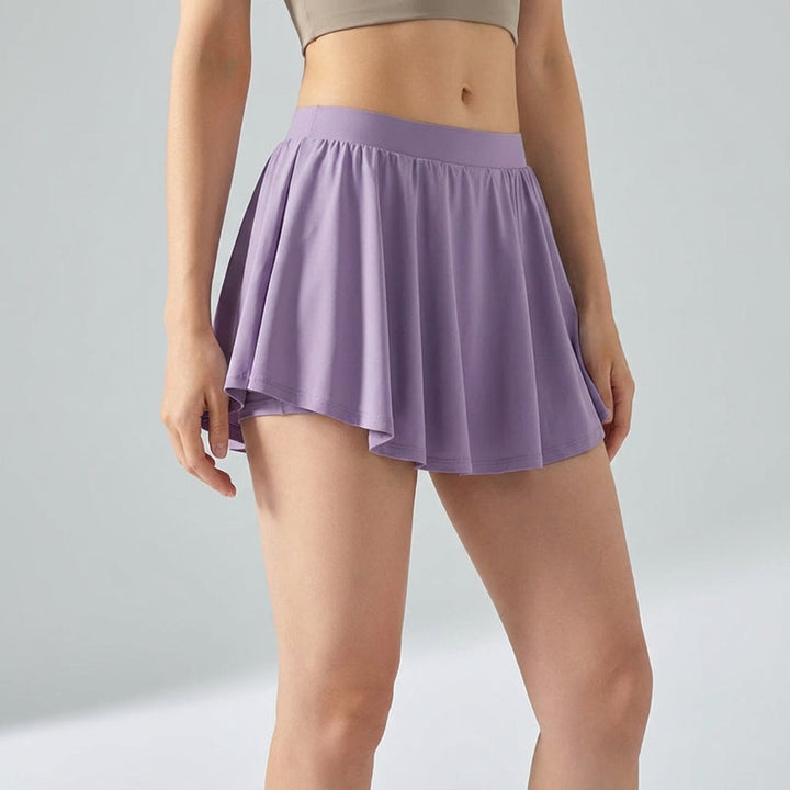 Model wearing Ava women's active mini skirt with built-in shorts, demonstrating comfort fit and style.