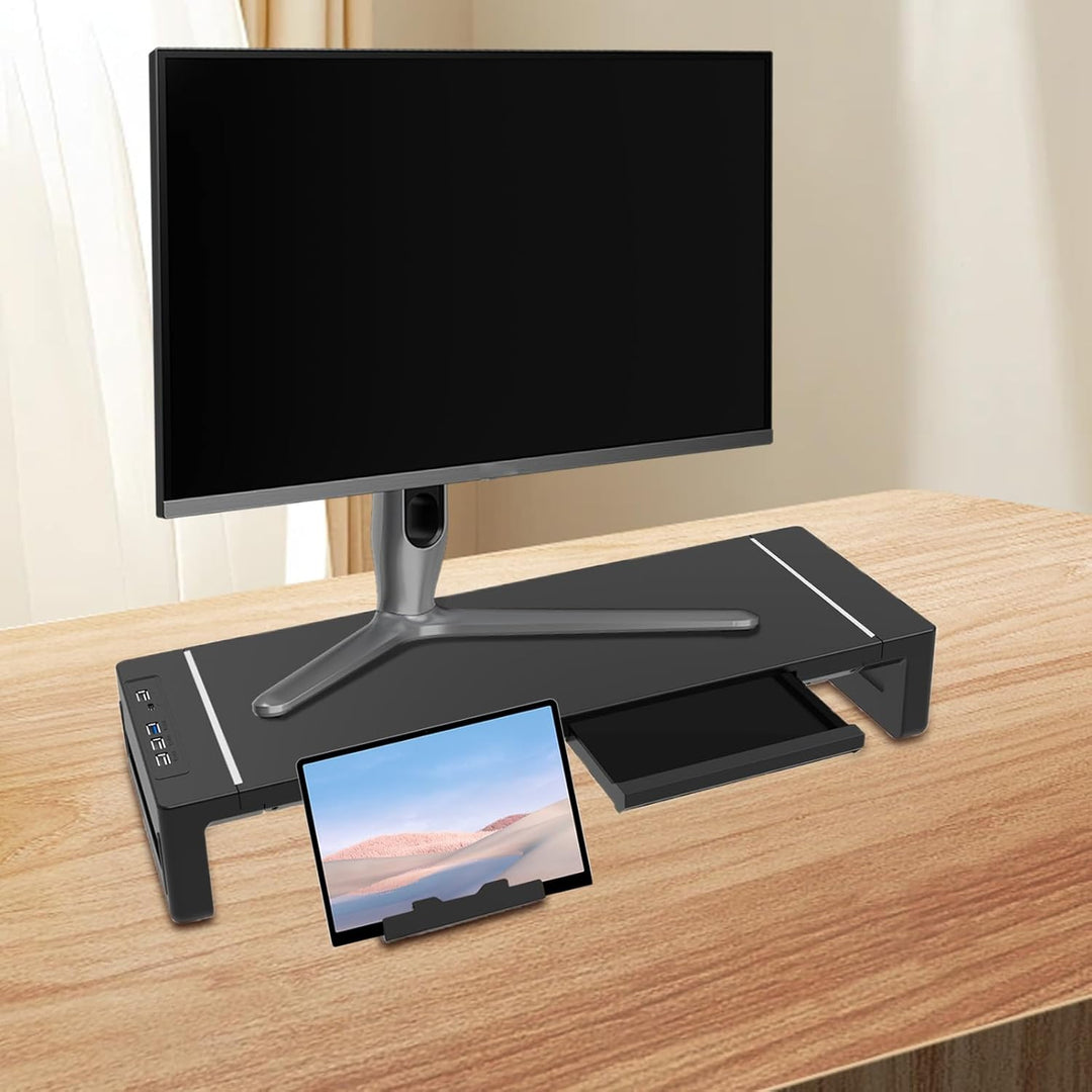 Ergonomic monitor riser in black, featuring a handy pull-out drawer and multiple USB ports