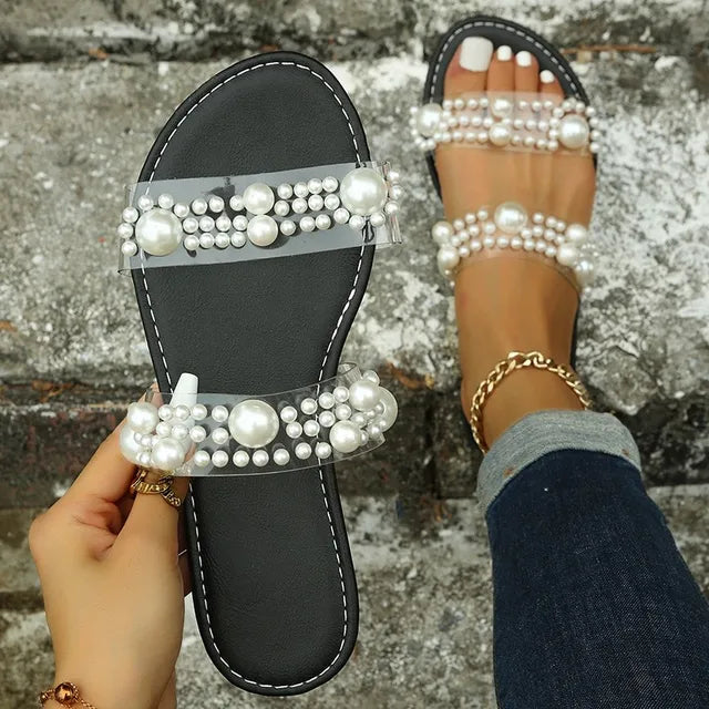 Bohemian slip-on flat sandals for women with elegant pearl embellishment, perfect summer footwear.