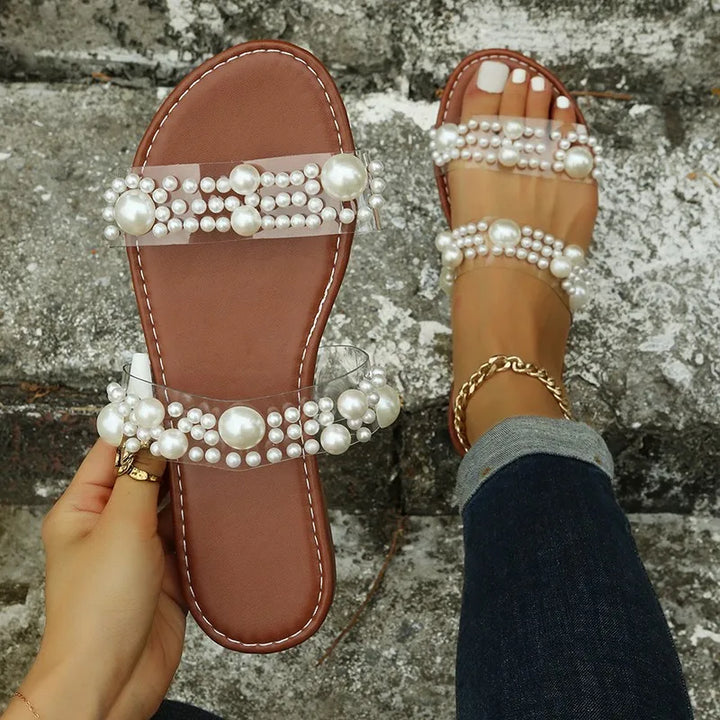 Elegant pearl embellished bohemian flat sandals, slip-on comfort for women's summer footwear.
