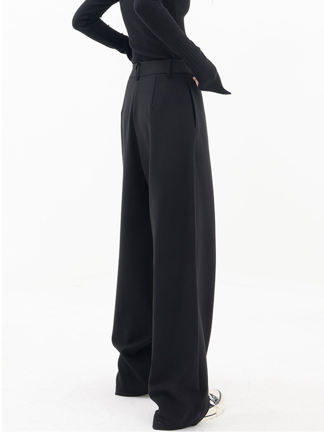 Women's chic asymmetrical baggy trousers, modern style, low waist. Comfortable & elegant fashion bottoms.