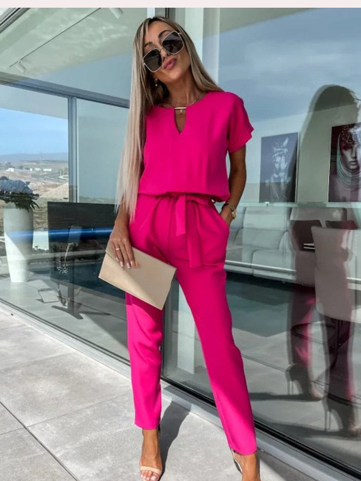 Chic women's short sleeve belted jumpsuit. Elegant and versatile one-piece for spring & summer fashion.