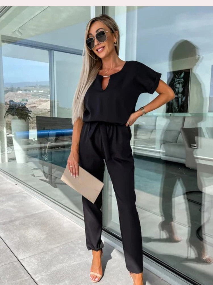 Women's short sleeve belted jumpsuit, a stylish and comfy one-piece. Perfect for versatile spring fashion.