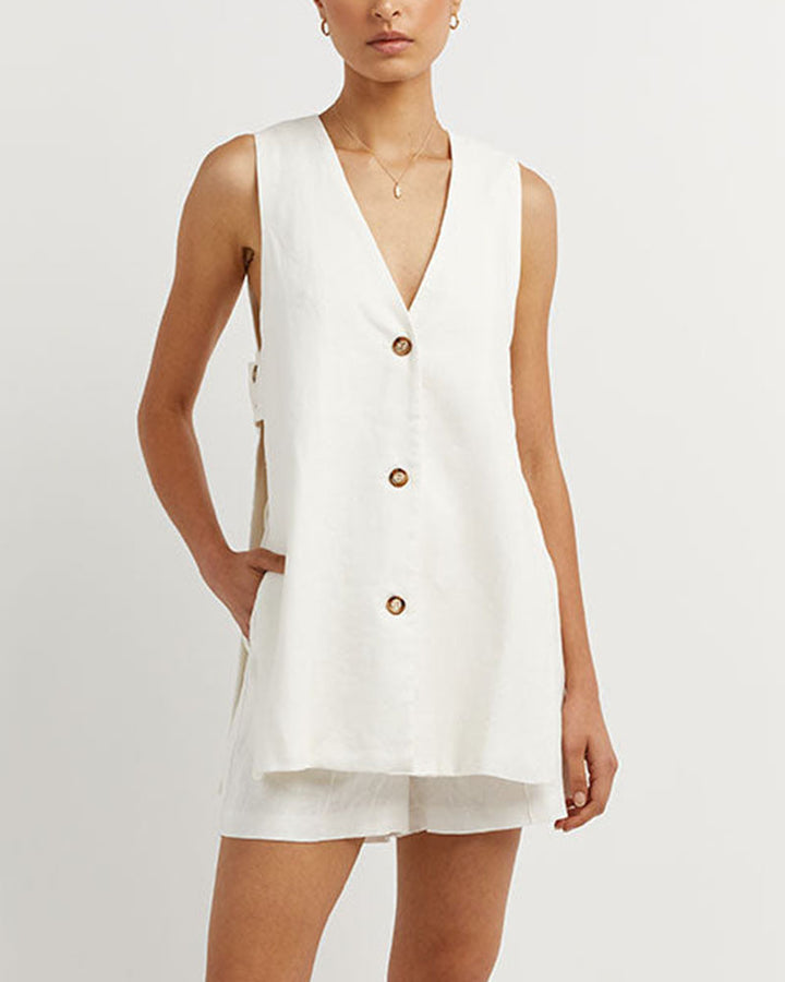 Stylish women's summer fashion set featuring a sleeveless gilet and high-waisted shorts. Trendy ladies outfit.