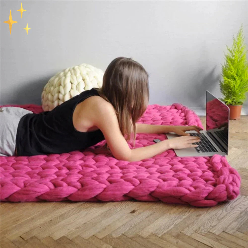 DIY blanket made with chunky wool yarn, showing finished product and texture.