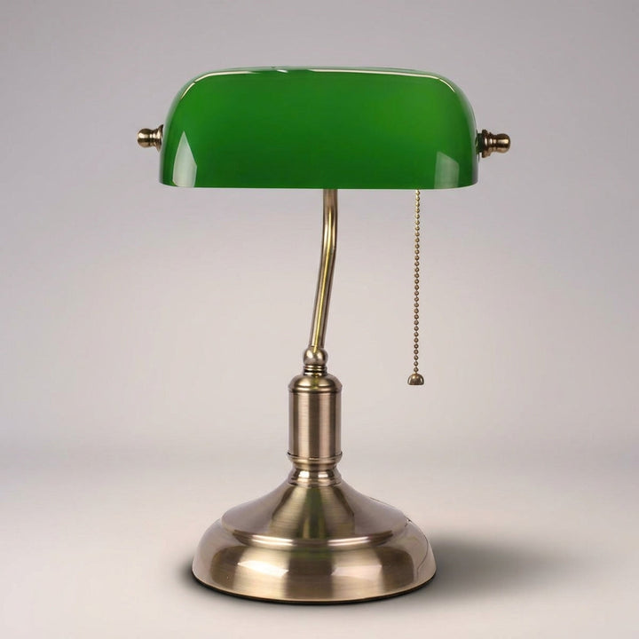 Vintage-style banker desk lamp with emerald green glass shade and polished metal base, ambient light