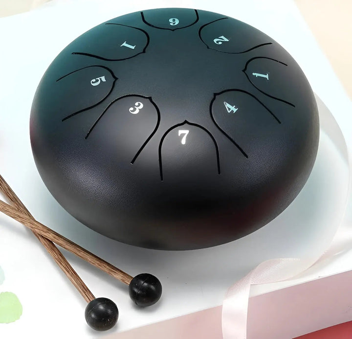 Unisex steel tongue drum in a serene setting, creating soothing sounds for stress relief.