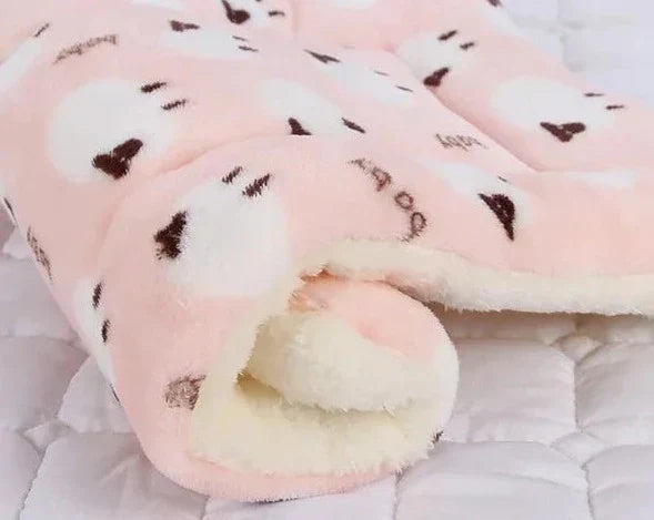 A fluffy SnuggleSoft cat blanket. Ultra-soft warming flannel pet supply promoting feline comfort and cozy naps.