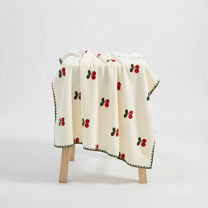 Detailed view of the high-quality cotton texture and cheerful fruit print of a TropiTowel, highly absorbent