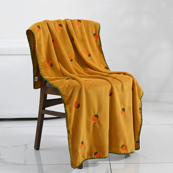 Assorted fruit pattern TropiTowel cotton towels in various bright colors, suitable for kitchen & bath