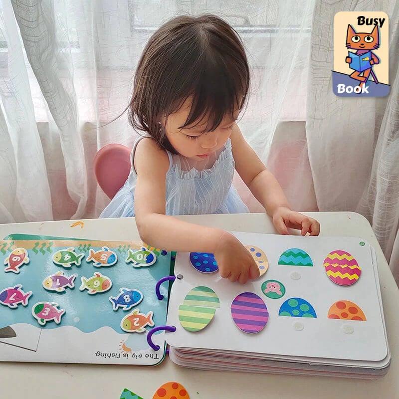 Interactive fabric book for children, designed for sensory exploration & developmental play in toddlers.