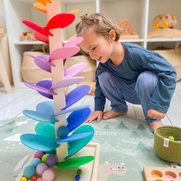 Vibrant rainbow marble sound tree, a wooden toy creating musical tones as marbles descend for sensory fun & exploration.