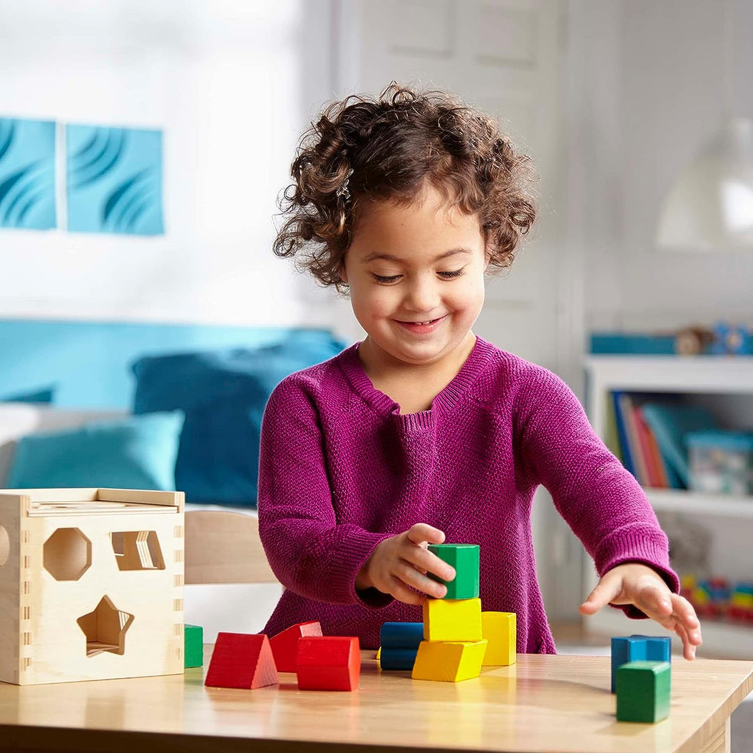 ShapeBox wooden learning toy helps toddlers recognize shapes & colors. Enhances fine motor skills & cognitive development.
