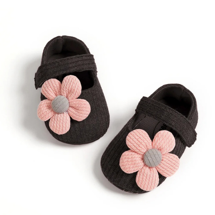 Soft sole infant footwear designed for baby's first steps, ensuring comfort & secure fit for toddlers.