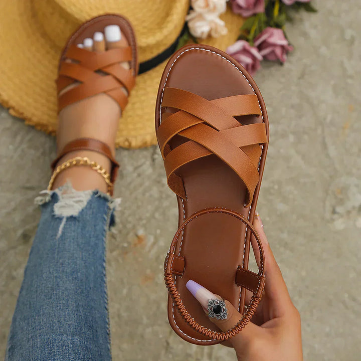 Stylish flat brown Roman sandals for women, featuring a secure non-slip sole, ideal for summer vacation.