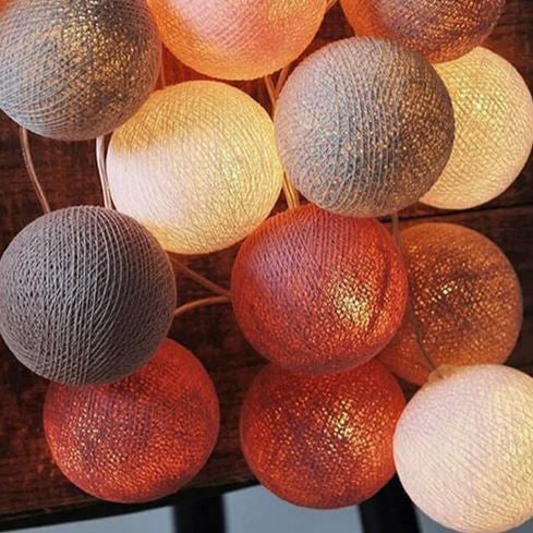 Decorative string lights featuring multi-colored cotton balls for vibrant party ambiance.