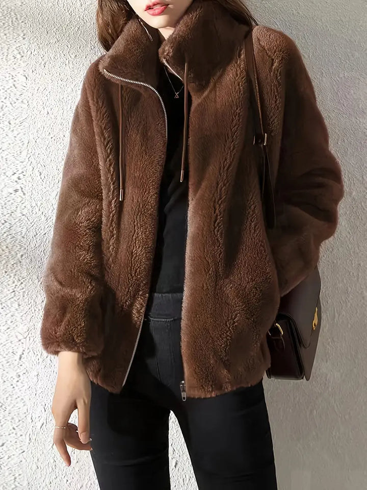 Warm & comfortable women's hooded teddy jacket, featuring a zip-up front and adjustable drawstring.