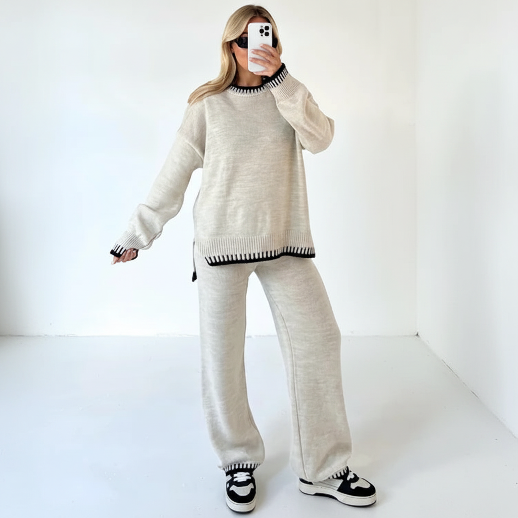 Woman relaxing at home wearing a stylish knitted two-piece lounge set in a comfortable, casual pose