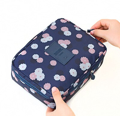 Compact waterproof cosmetic case, dark blue floral, excellent for beauty storage.
