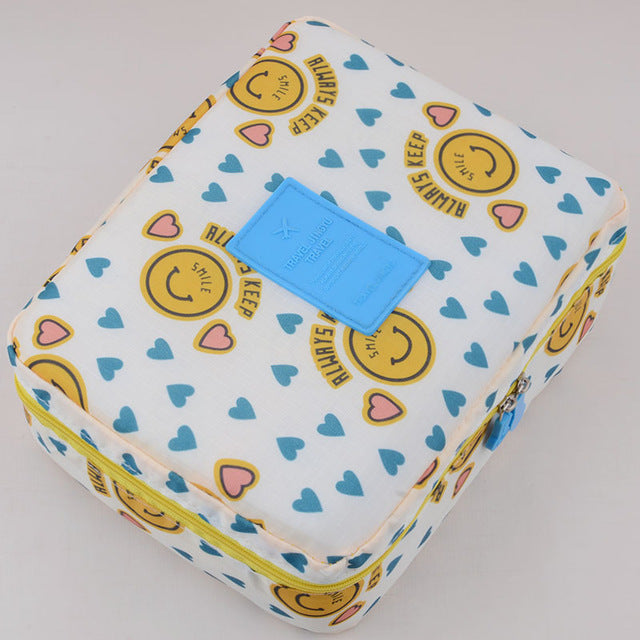 Travel-friendly dark blue floral waterproof cosmetic case for beauty essentials.
