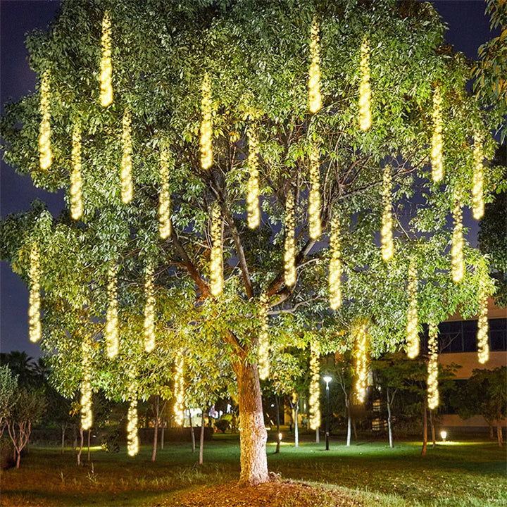 Weatherproof LED meteor shower string lights hanging from a patio pergola, creating a magical party atmosphere.