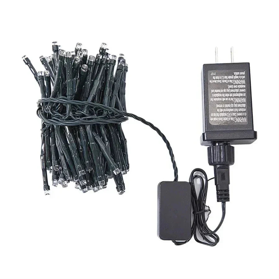Vibrant LED meteor shower lights decorating a garden bush, adding whimsical outdoor lighting and festive flair.
