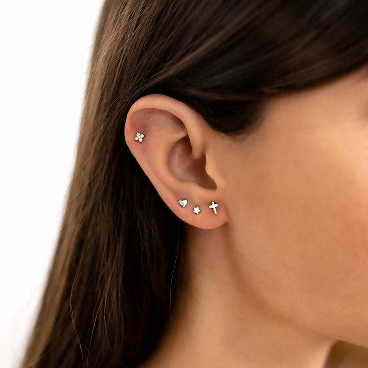 Subtle gold plated cross stud earrings, a delicate touch for women's minimalist jewelry style.