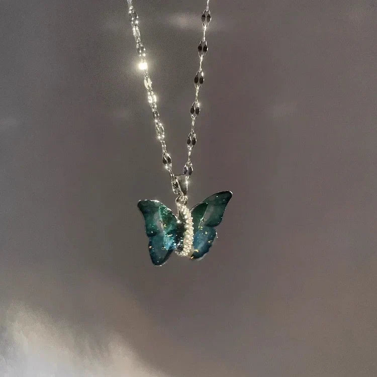 Delicate sterling silver blue butterfly necklace for women. Features a vibrant blue enamel butterfly pendant, perfect for animal lovers.