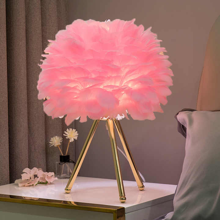 Modern dimmable feather table lamp, adjustable mood lighting for elegant home decor in bedroom or living room.