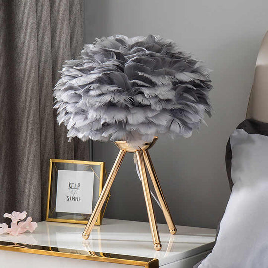 Elegant dimmable feather lamp for a bedroom or living room, offering modern luxury and cozy mood lighting.