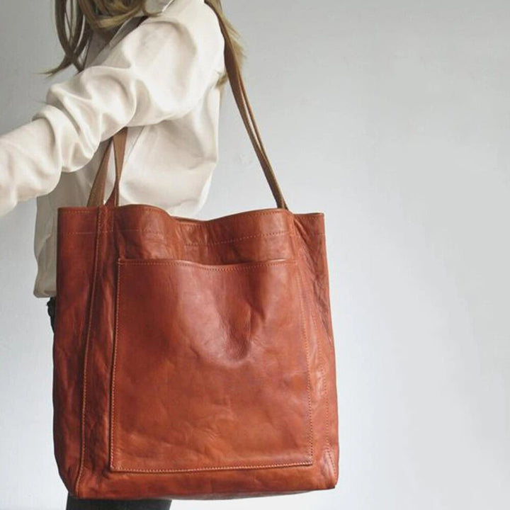 Stylish women's elegant leather shoulder bag. Durable fashion handbag, available in black, light, or dark brown.
