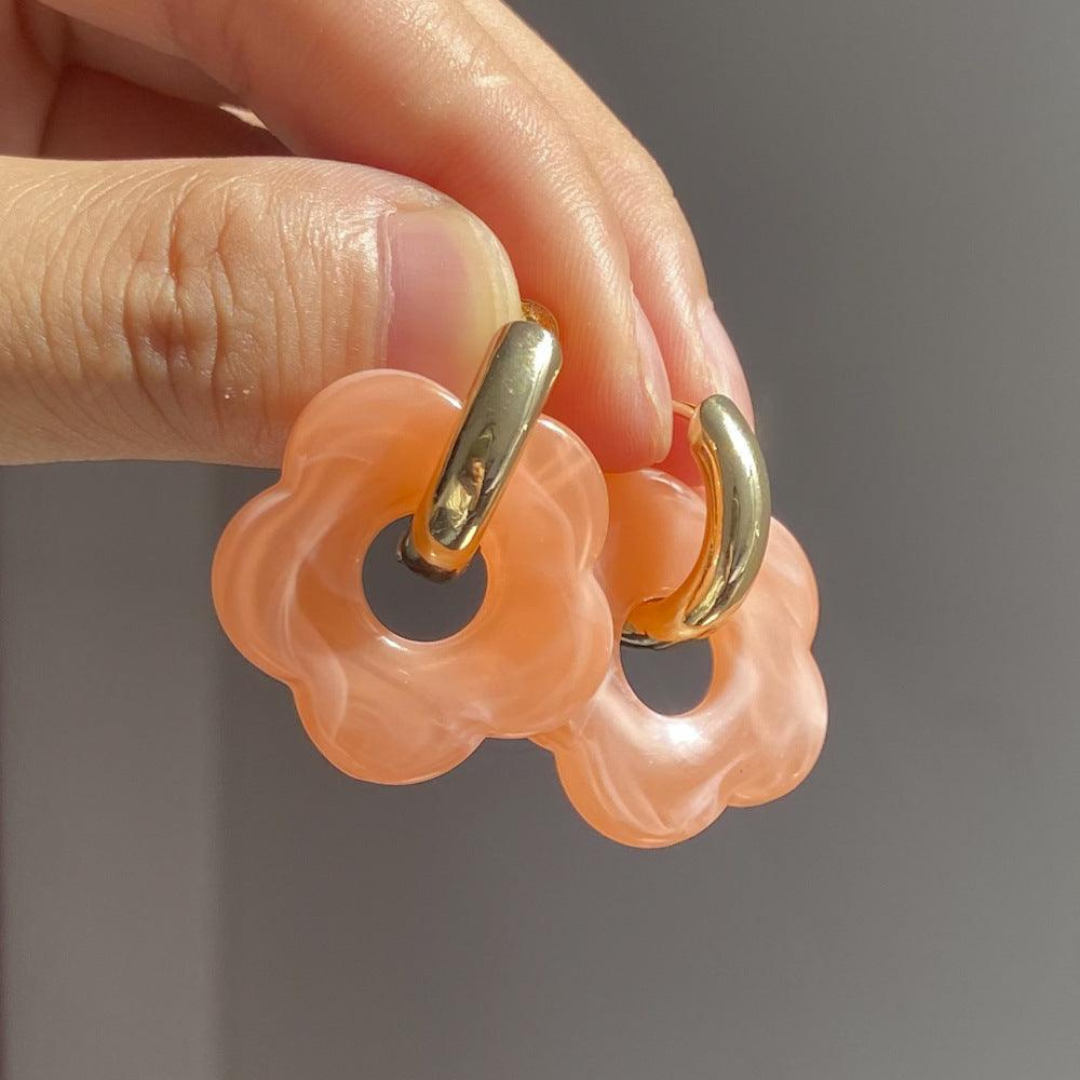Women's shimmering gold flower earrings, a stylish elegant fashion accessory.