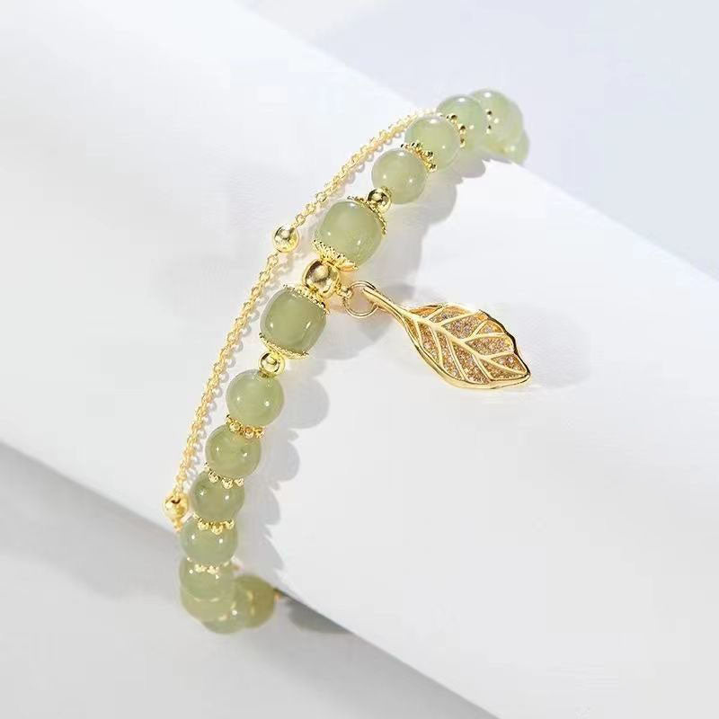 Elegant green jade leaf bracelet for women. Natural stone, adjustable fit. Perfect nature-inspired jewelry.