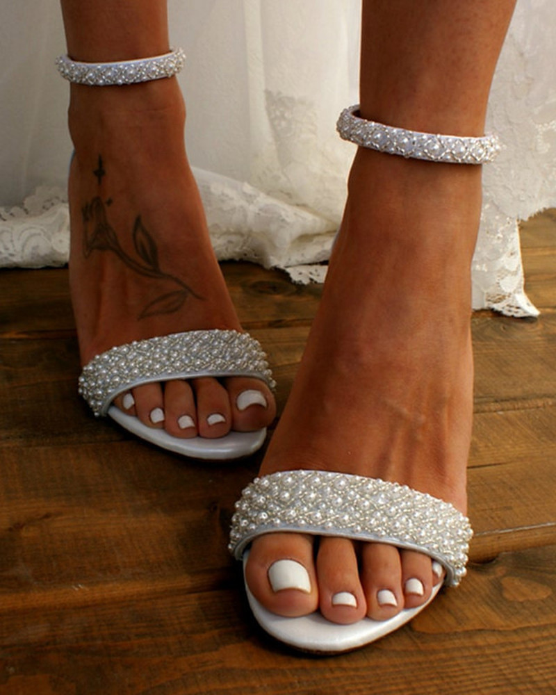 Comfortable women's bridal heels, ivory, with elegant delicate straps and secure ankle closure, perfect wedding footwear.
