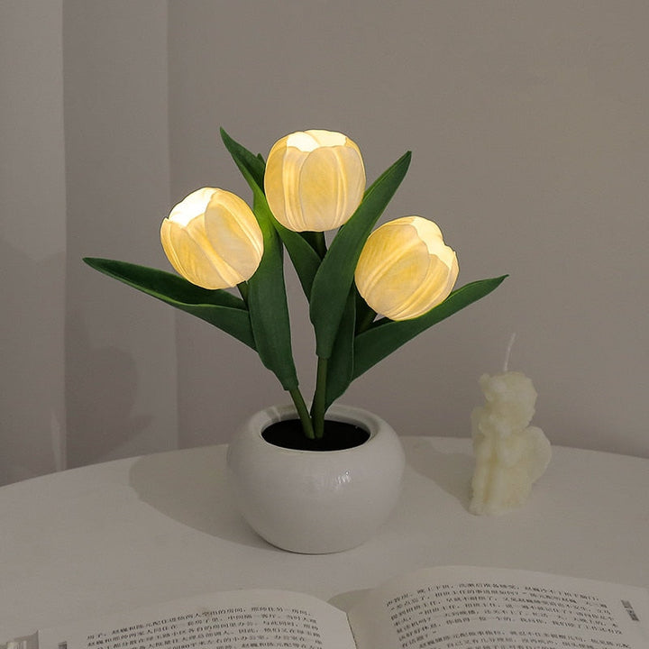 Modern LED tulip lamp shining softly, a sophisticated home decor and mood lighting piece.