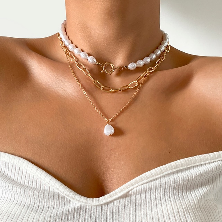 Woman wearing an elegant multi-layer pearl necklace, a timeless and classic fashion statement.