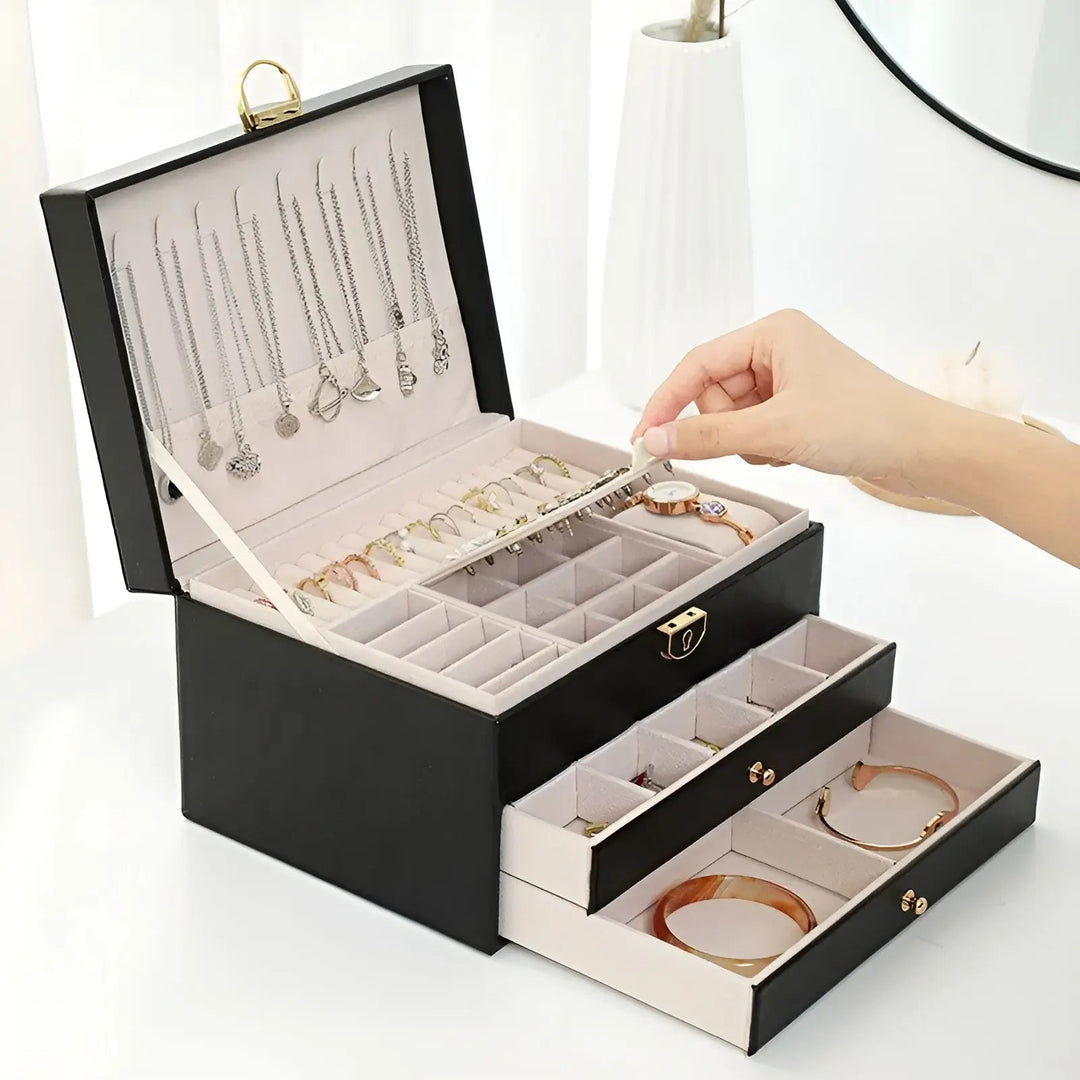 Elegant multi-layer vegan leather jewelry box, perfect for organizing necklaces & rings on a dresser.