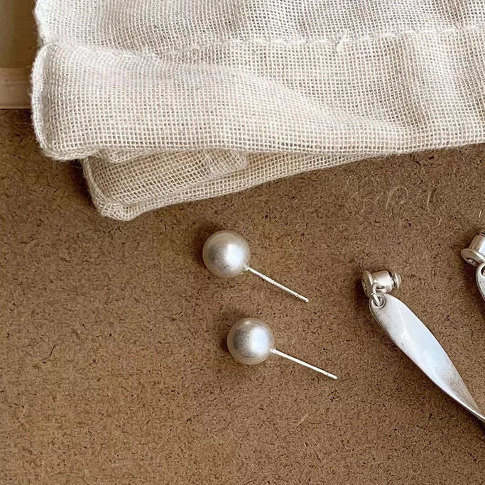 Elegant silver wave stud earrings for women. Delicate and fashionable jewelry, a perfect gift for her.