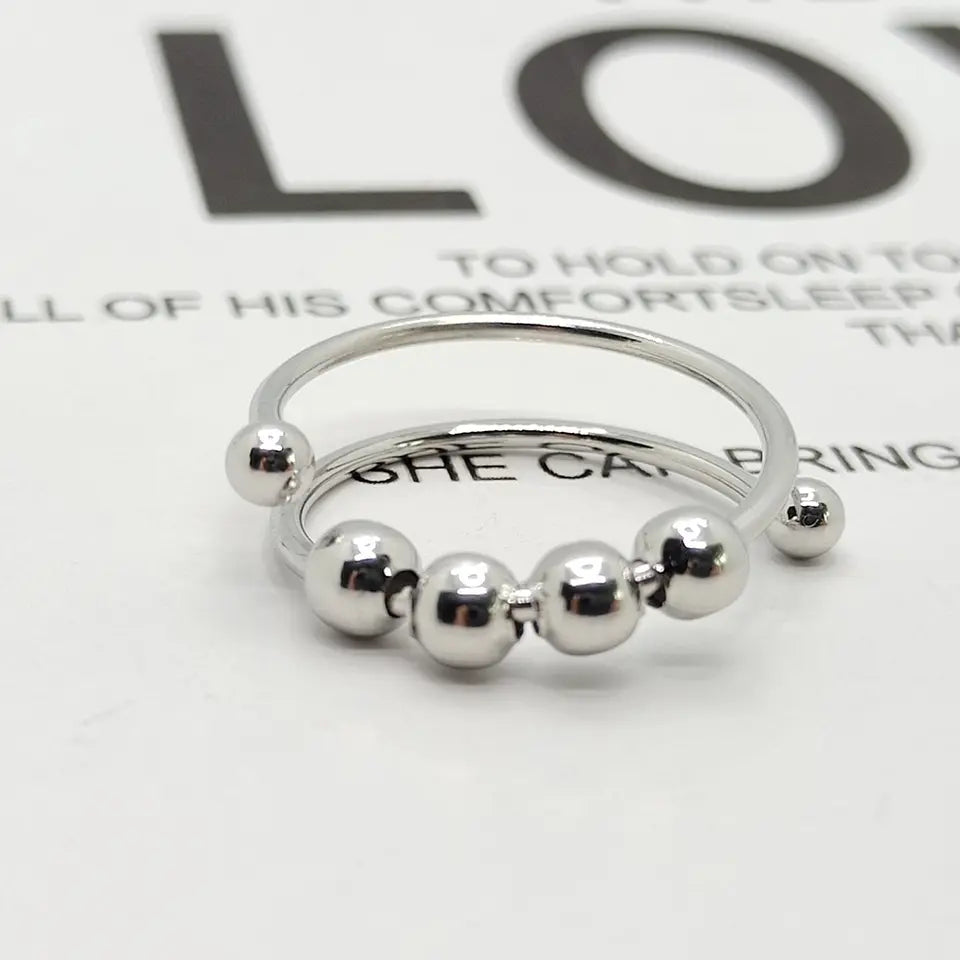 Elegant silver women's anti-stress fidget spinner ring for anxiety relief & mindful stress reduction.