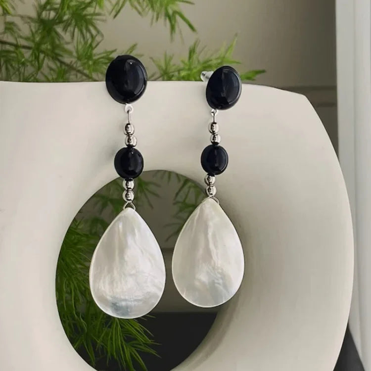 Retro style women's vintage shell drop earrings, beach inspired, elegant summer fashion accessory.