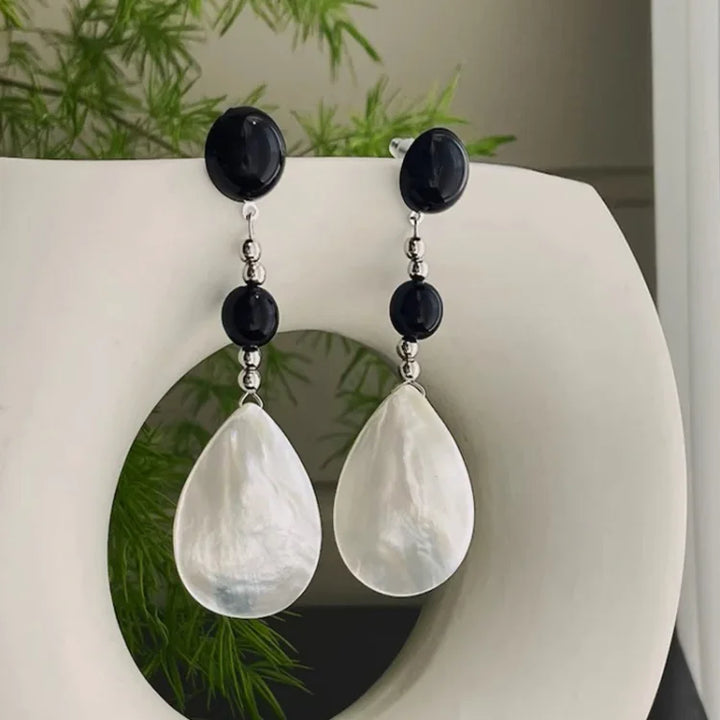 Retro style women's vintage shell drop earrings, beach inspired, elegant summer fashion accessory.
